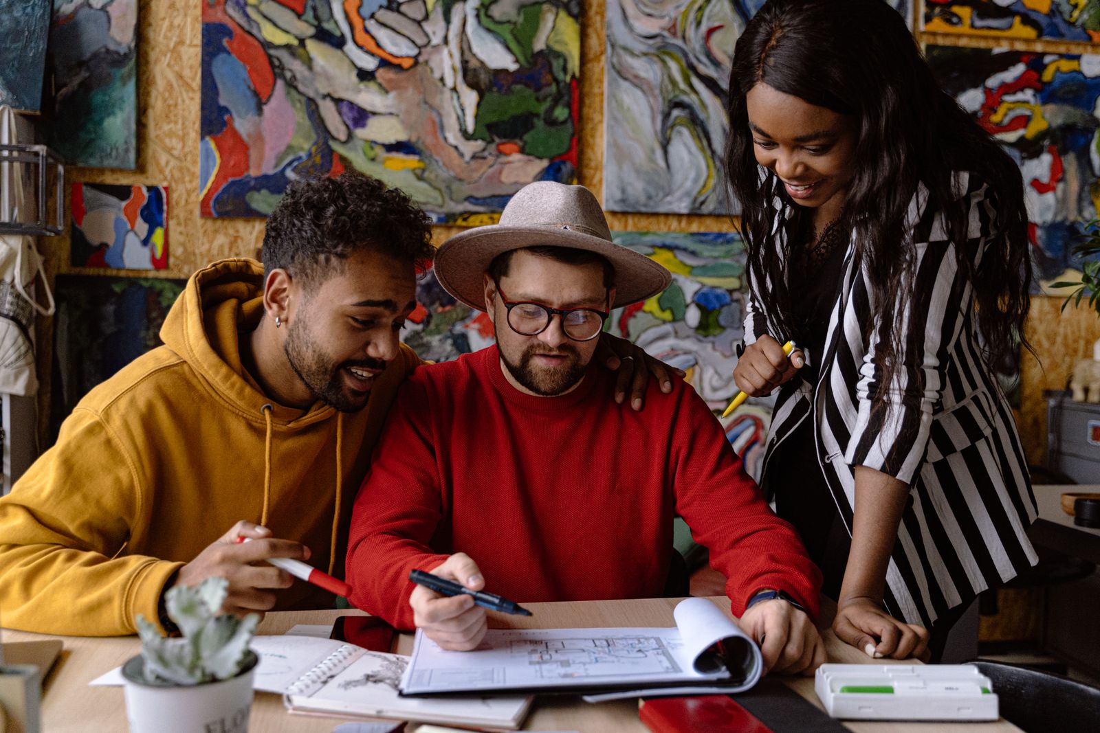 A diverse team collaborating in a colorful creative studio